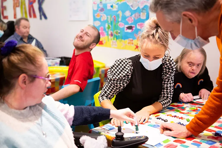 Care workers doing arts and crafts with residents