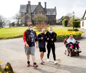 Proud2Care-0613 Support workers and service users going for a walk