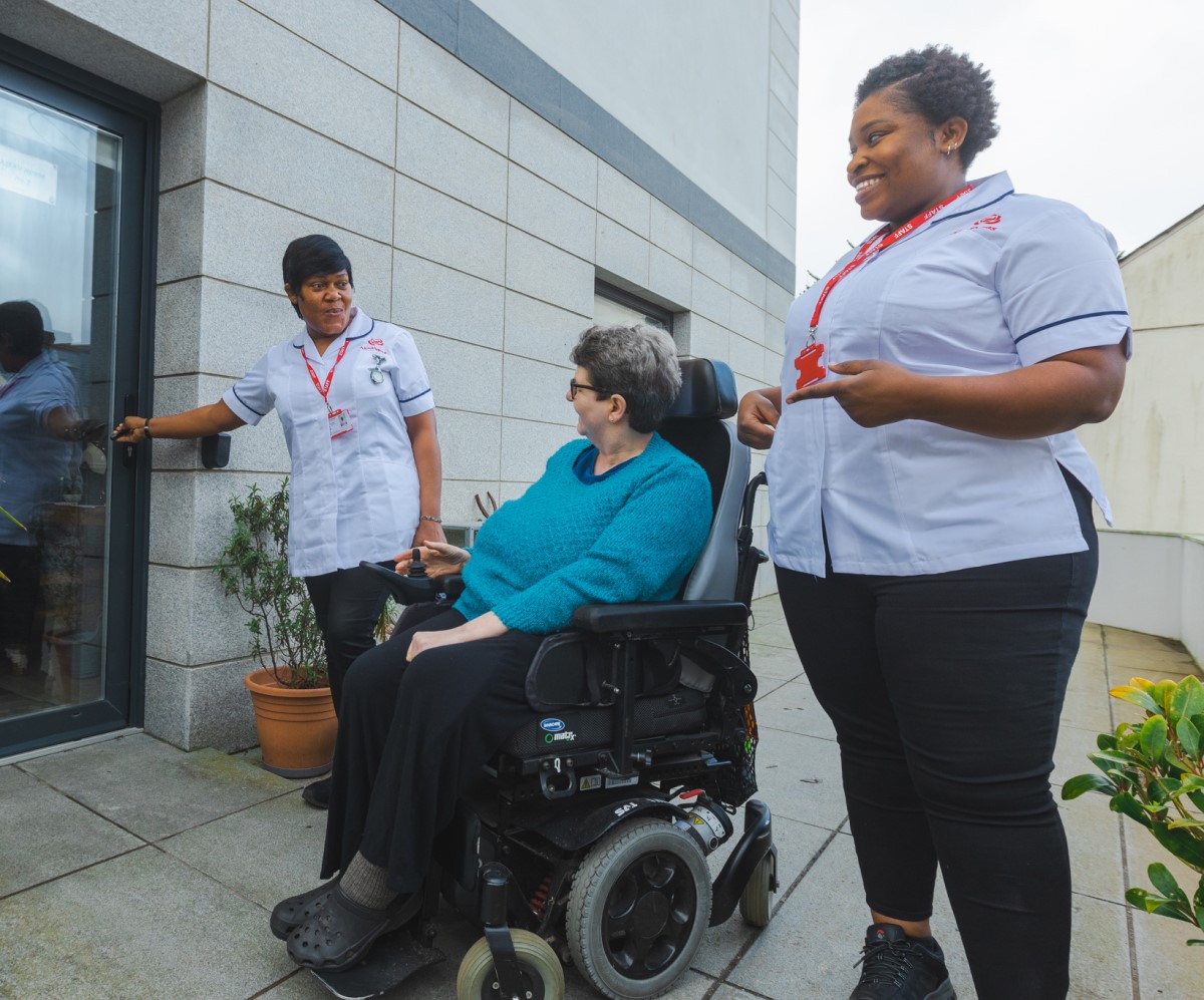 International care workers with a service user
